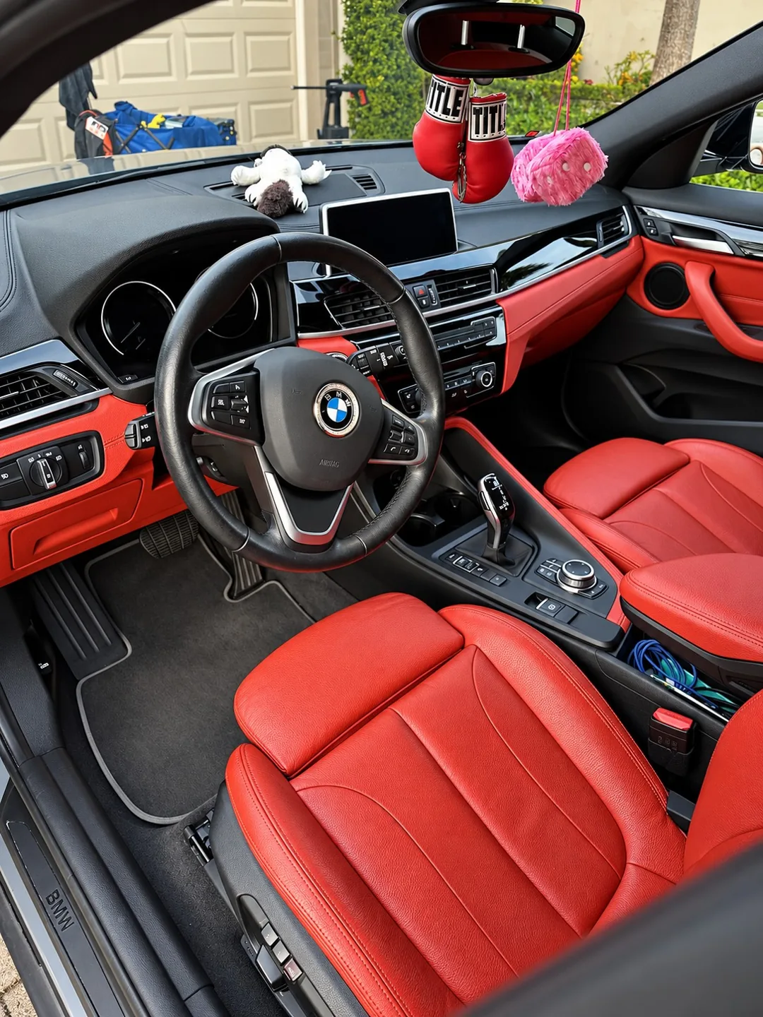 Red BMW leather seats and dashboard after interior detailing